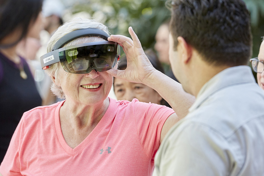 An older woman wearing VR glasses
