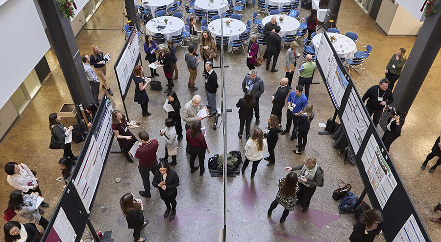 Overhead photo of crowds looking at research posters
