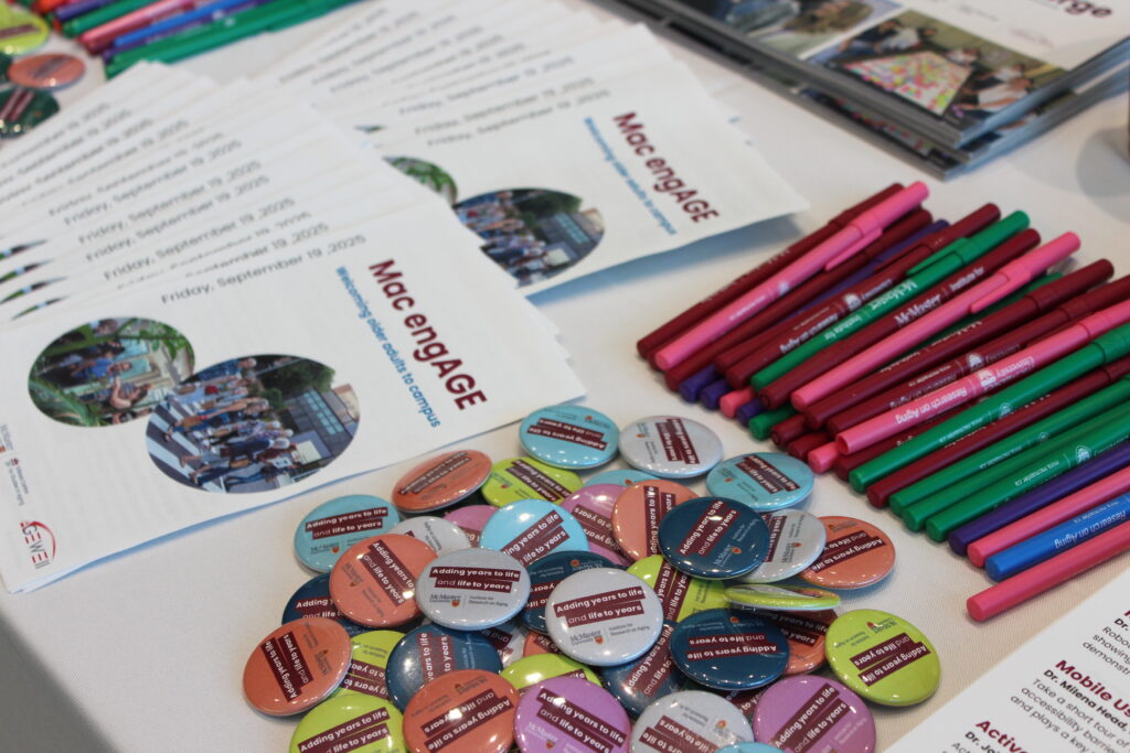 Mac engAGE registration table with program, buttons, and pens