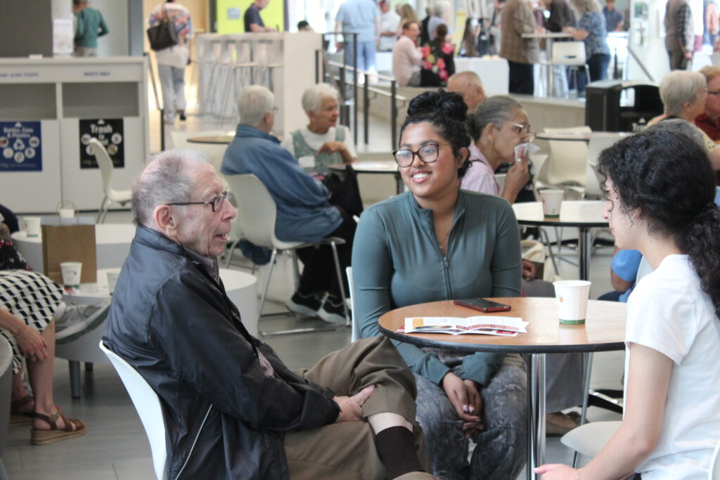 Mac engAGE attendee and student volunteers conversing