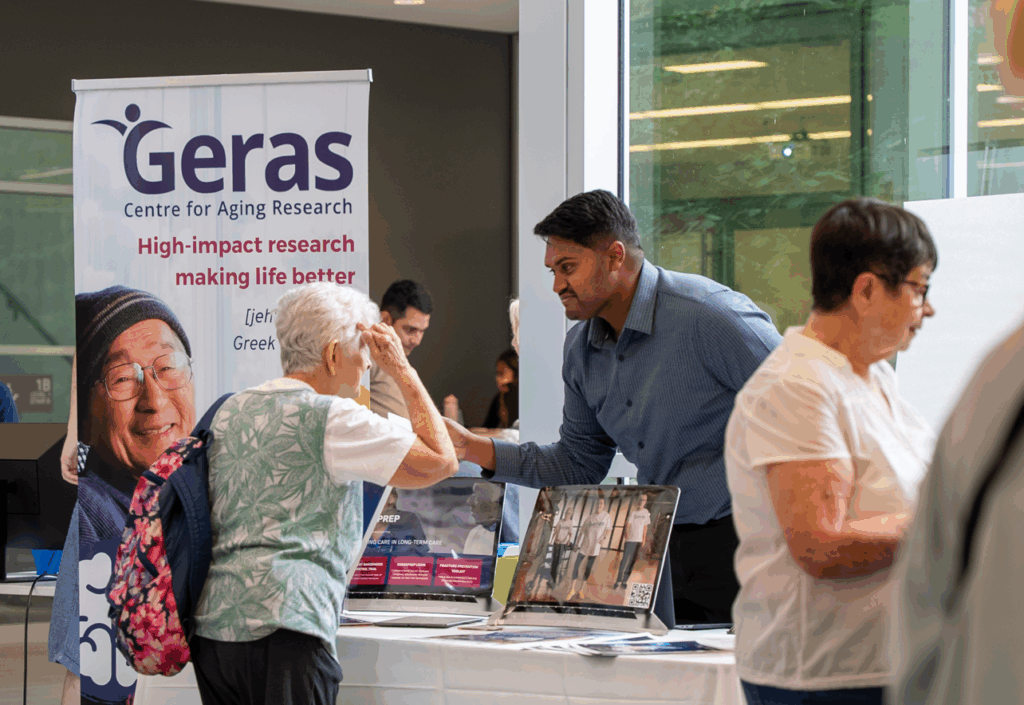 Mac engAGE attendee and GERAS researcher conversing