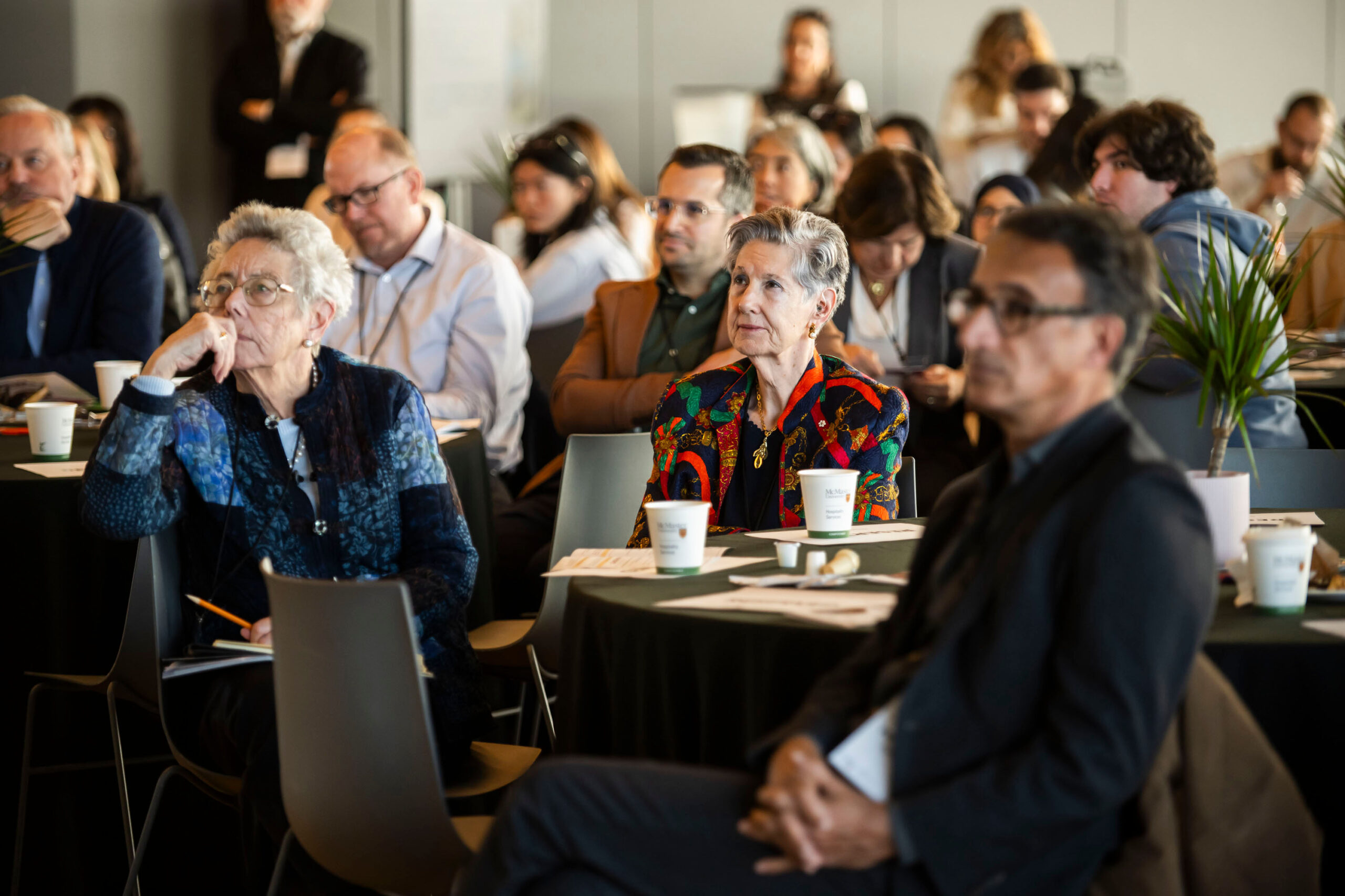 An audience watches a presentation.