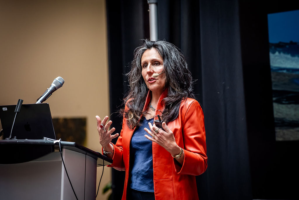 Caterina Rosano speaks on a microphone