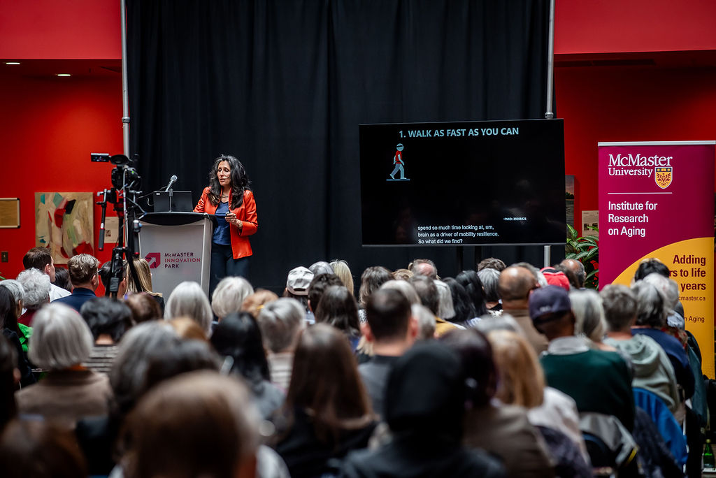 Caterina Rosano speaks to an audience from a stage