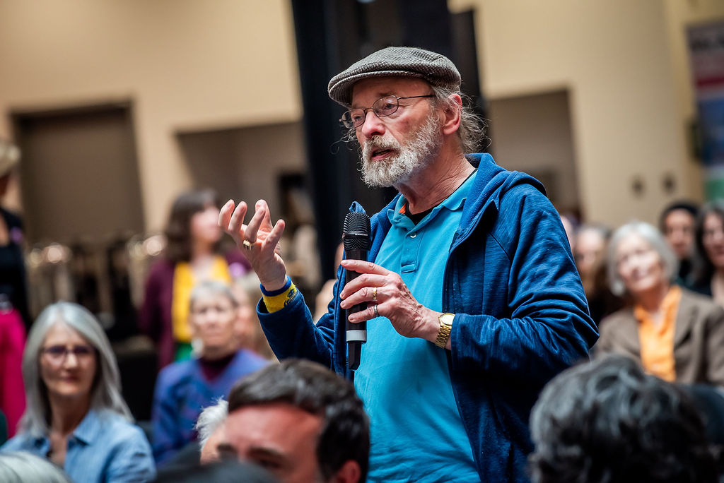 Community member asks a question with a microphone